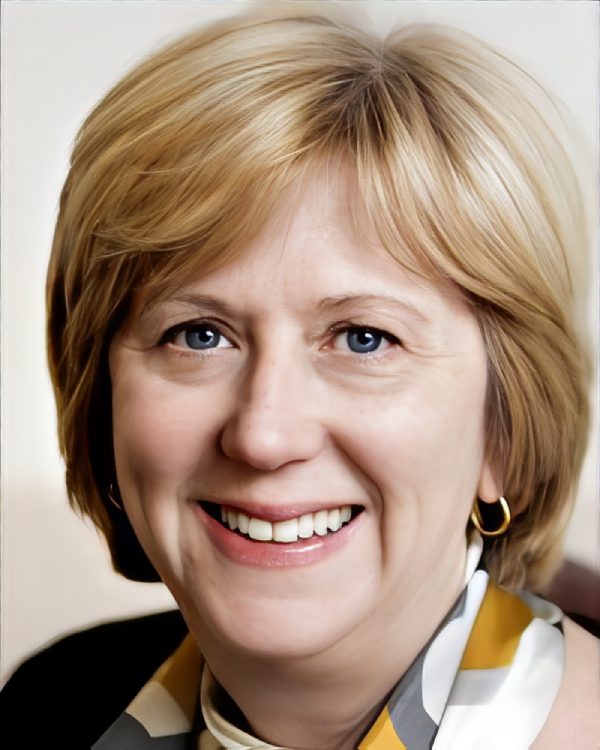 Smiling woman with short blonde hair.