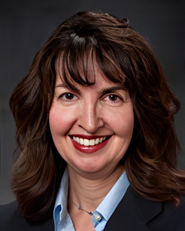 Smiling woman with dark hair and bangs.