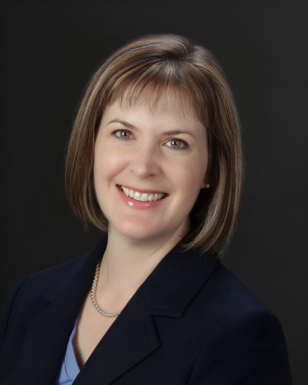 Smiling woman with short brown hair.
