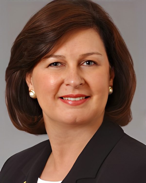 Woman in professional attire, smiling portrait.